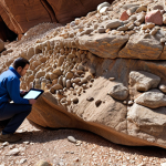 **Data Analysis:** A geoscientist using AI-powered software to analyze a large dataset of rock samples, revealing hidden patterns.